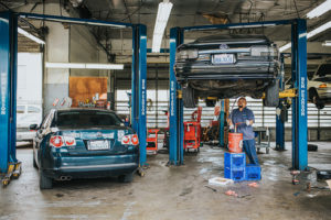 3 cars being worked on by skilled mechanic at Bucky's Auto Repair Federal Way