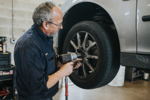 Car being repaired by mechanic at Bucky's Lakewood Auto repair location