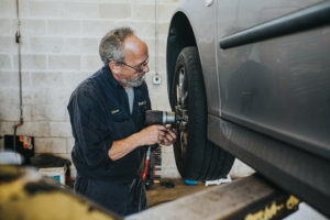 Car being repaired by technician at Bucky's Lakewood Auto repair location