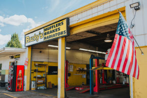 American flag in front of two car garage at Bucky's Fife Auto Repair