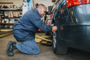 mechanic examining a tire at Bucky's Fife Auto Repair
