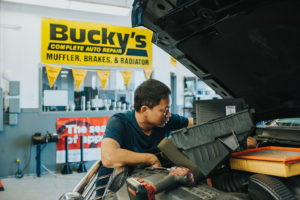 Mechanic repairing car at Bucky's Shoreline Auto repair location